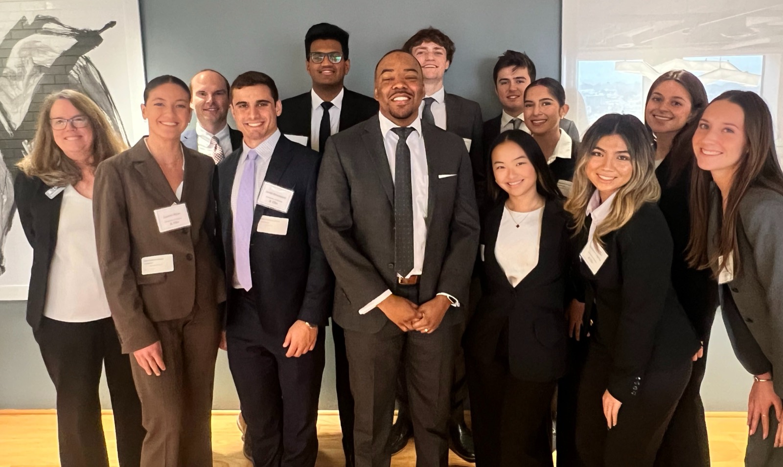 Kelsey Wilson with attendees at a BlackLines community seminar, everyone wearing name badges